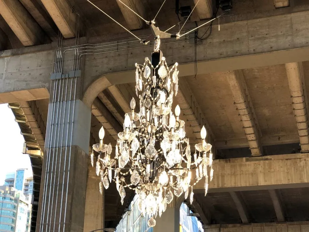 The spinning chandelier artwork hanging under the Granville Street Bridge, raised and lowered by six Columbia hoists